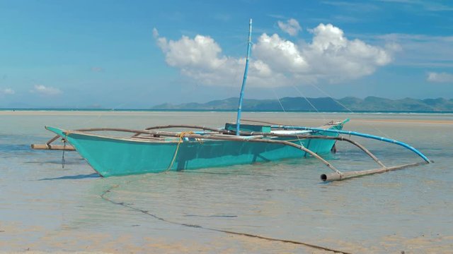 Traditional filipino bangka boats anchored on gorgeous tropical beach. Travel concept. Palawan island, Philippines.