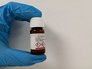 Object isolated on white background. Chemical reagent in an amber bottle.