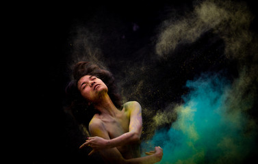 model Asian girl emotion posing and movement with dust color on dark background