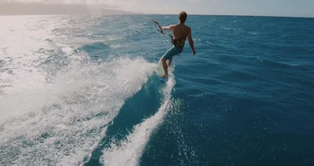 Young athletic man kitesurfing POV follow cam in slow motion, extreme action sports POV, tropical island surf adventure