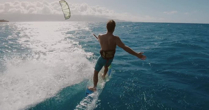 Young athletic man kitesurfing POV follow cam, extreme action sports POV, tropical island surf adventure