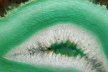 Green agate stone macro. Green agate arc slice texture.Natural stone bright Green background. Phone wallpaper
