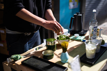 Japanese man making matcha green tea in tokyo street stall ginza