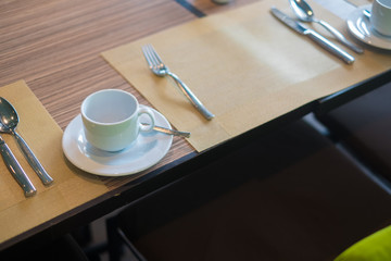 Cup of hot coffee on dinning table in restaurant for breakfast.