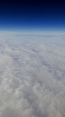 The beautiful cloudscape with clear blue sky. A view from airplane window.