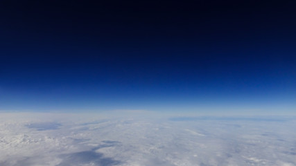 Naklejka na ściany i meble The beautiful cloudscape with clear blue sky. A view from airplane window.