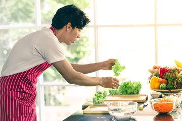 Asian man are preparing a salad plate..