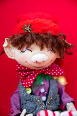 toy rag doll on red background. Art soft focus