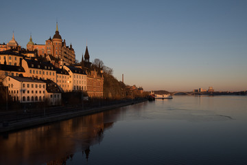 Fototapeta premium View over old houses in the Södermalm district a spring day at sunrise in Stockholm from the Riddarholmen island