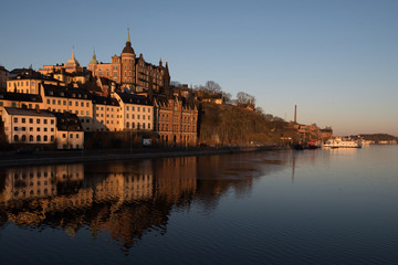 Naklejka na ściany i meble View over old houses in the Södermalm district a spring day at sunrise in Stockholm from the Riddarholmen island