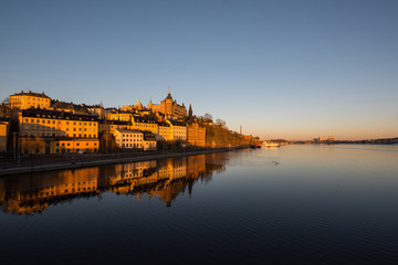 Fototapeta na wymiar View over old houses in the Södermalm district a spring day at sunrise in Stockholm from the Riddarholmen island
