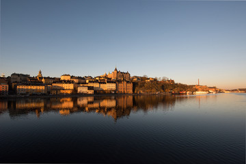 Fototapeta premium View over old houses in the Södermalm district a spring day at sunrise in Stockholm from the Riddarholmen island