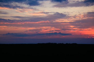 Beautiful sunset. Blurred image of the dramatic sunset in the steppes in the Astrakhan region. Russia. Dramatic clouds as a natural background.