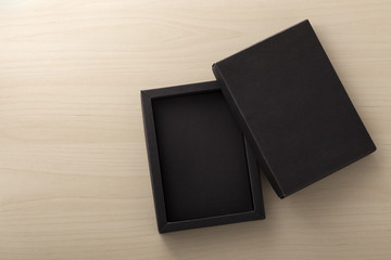 Black box packaging on wooden background