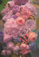 Flower arrangement of different colors. The photo is processed in vintage style, toning and light blur.