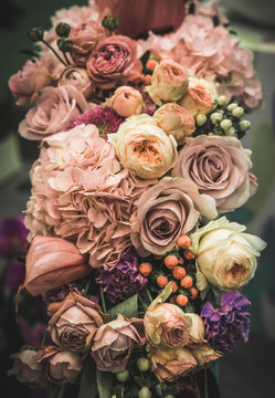 Flower arrangement of different colors. The photo is processed in vintage style, toning and light blur. © Tetiana Liubarska