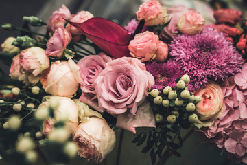 Flower arrangement of different colors. The photo is processed in vintage style, toning and light...