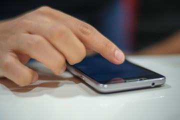 Man's hand using mobile phone