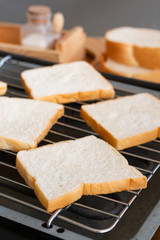 Slices bread on toaster.