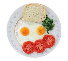 fried eggs with tomato and bread on white background