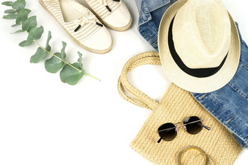 Top view, flat lay fashion women summer clothes and accessories.Straw hat, sunglasses, denim, bag, shoes on white background.