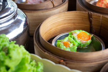 Dim sum stuffed crab in tray on wooden table.
