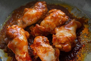Spicy drumstick or Fried chicken with tomato sauce and black pepper in bowl.