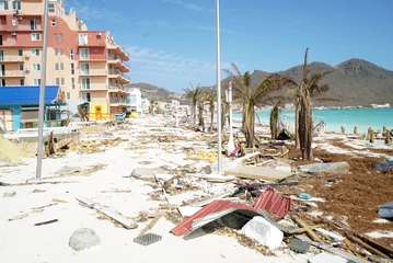Papier Peint photo Descente vers la plage Philipsburg Sint maarten: Board walk and buildings completely covered with beach sand and debris after island got hit by hurricane Irma. 