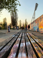 Bench in park  at graffiti wall at Mauerpark in Berlin, Germany