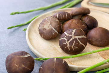 shiitake in wooden dish on concrete table.