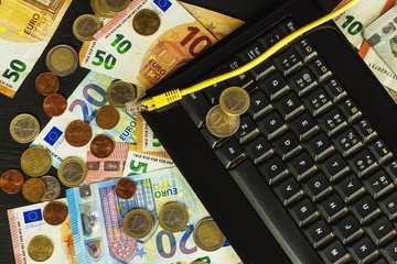 Computer keyboard and euro banknotes. Internet banking. Networking. Secure payments.