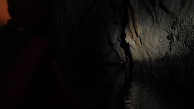 Floating inside Underground river by boat, Sabang, Philippines. Dark lighting with the real feeling from visitor's point of view. Wonder of the World.