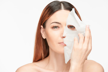 Woman peeling mask off