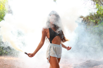Beautiful girl holding a ink smoke bomb