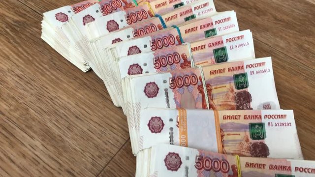 Stack of bills in packs of Russian ruble money on the floor