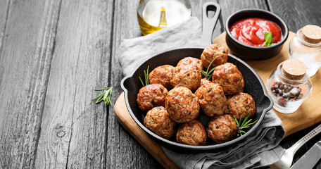 Meatballs served with tomato sauce in frying pan . - obrazy, fototapety, plakaty