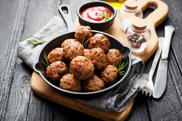 Meatballs served with tomato sauce in frying pan . - 263181280