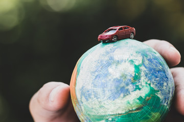 Eco friendly Save world concept. Red car and Hands holding Model globe clay with radar Natural background. Ideas of earth maintenance by reducing energy consumption, Travel around the world