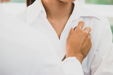 Doctor checking heart body patient by stethoscope Asian Female that get sick with clipboard on desk in hospital. Healthcare medicine concept.