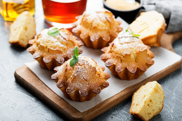 Fresh homemade delicious vanilla muffins with powdered sugar.