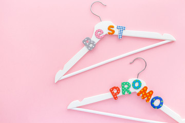 White hangers with sale text on pink background