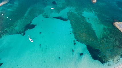 Amazing drone aerial landscape of the charming area of Es Trencs and the boats with a turquoise...