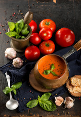 Tomato and fresh basil soup with garlic, served with cream