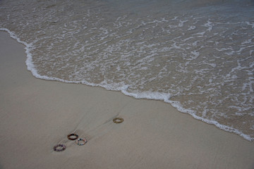 Colorful bracelets on a sand beach