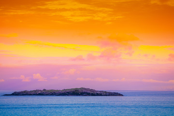 Island on the horizon. Rocks in the sea. Beautiful rocky sea landscape in evening. Wild nature Norway, seascape. Gradient color