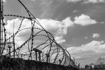Lantern and barbed wire with connected electricity, black and white photo.