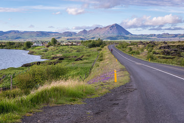 Road on the shore of Myvatn Lake seen from a road near Reykjahlid town in Myvatn region, located in north part of Iceland