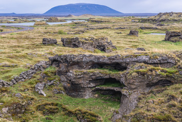 Rocks along shore of Myvatn Lake seen from a road near Reykjahlid town in Myvatn region, located in north part of Iceland