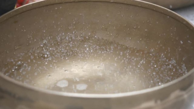 A singing bowl with water inside.