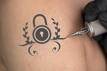 Hand tattooing colorful communication, leadership and creativity concept on naked clear skin